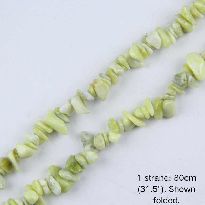 Close-up of 5-8mm pale green natural lemon jade stone chips strung on nylon cord.