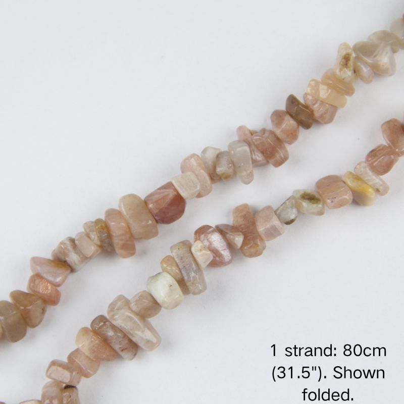 Close-up of 5-8mm warm natural sunstone stone chips with natural inclusions strung on nylon cord.