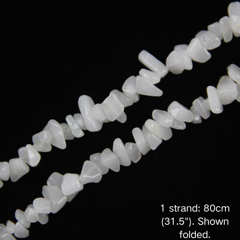 Close-up detail of white jade stone chips 5-8mm irregular shapes strung on nylon cord for DIY crafting.