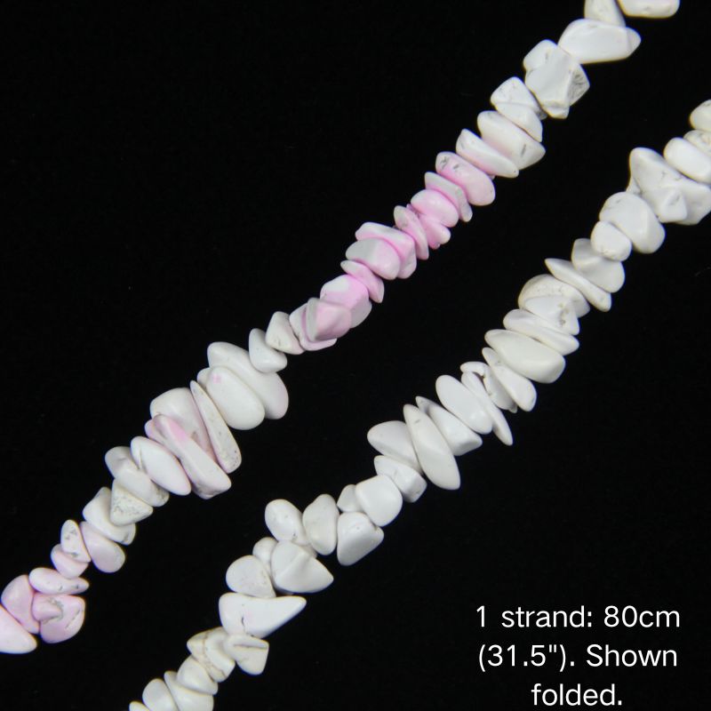 Macro close-up of dyed pink white explosion howlite chip beads, 5-8mm irregular chips, visible dye penetration and crack lines.