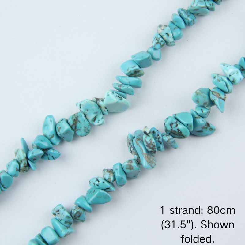 Close-up detail of dyed turquoise howlite chip beads showing 5-8mm irregular nuggets with vibrant blue-green base and natural crack lines.