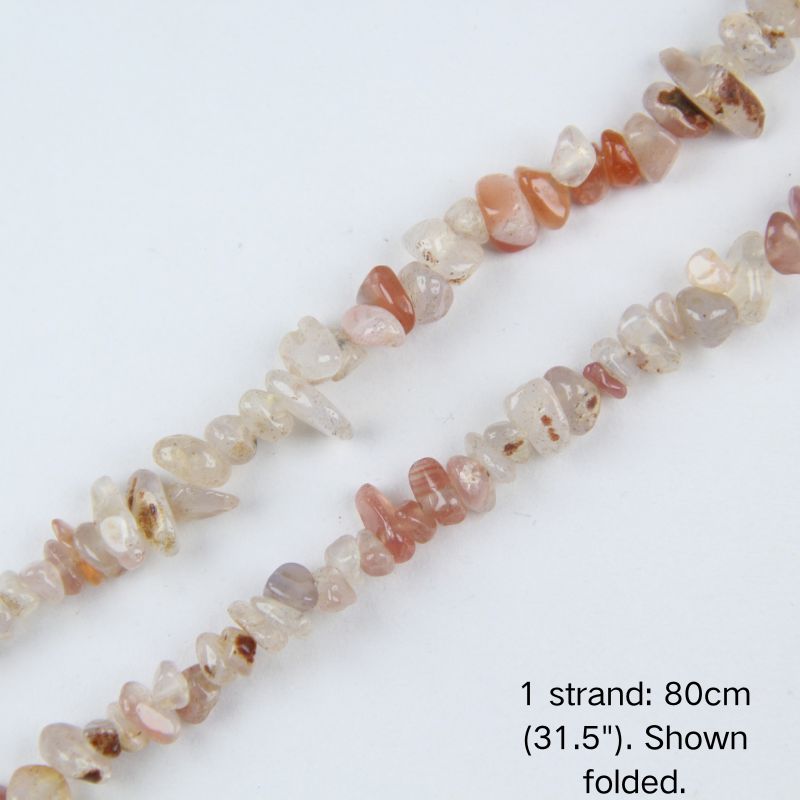 Close-up detail of natural Red and White Agate chip beads showing 5-8mm irregular nuggets with natural stone banding.