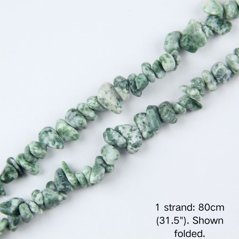 Close-up detail of natural Tree Agate chip beads showing 5-8mm irregular nuggets with creamy white base and moss-green speckles.