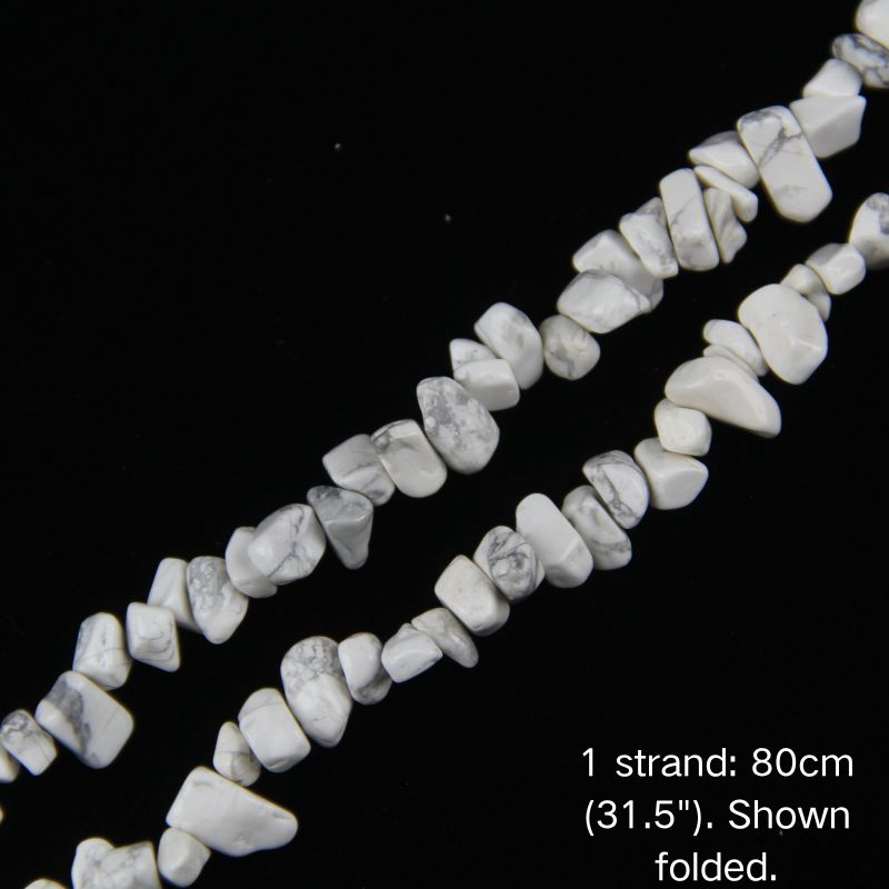 Close-up detail of natural white howlite chip beads showing 5-8mm irregular nuggets with creamy white base and grey veins.