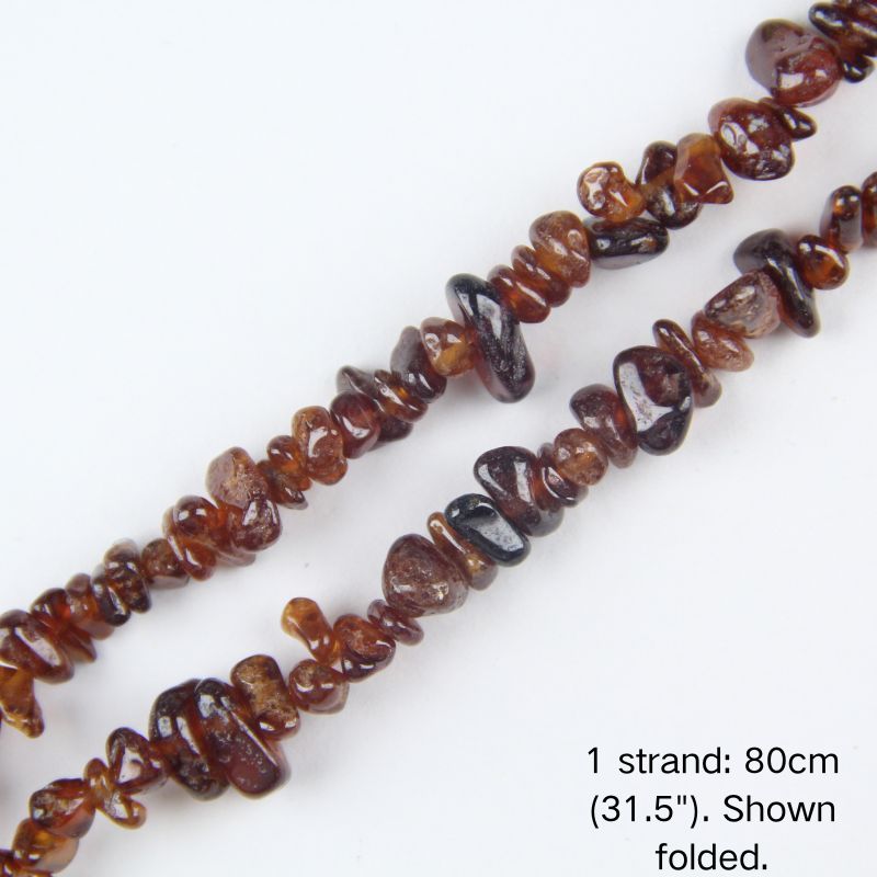 Close-up view of orange garnet chip cord, 80cm folded, showing 5-8mm natural raw stones with warm translucent glow.