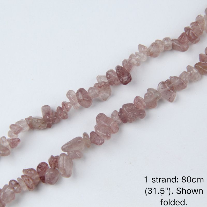 Macro close-up of strawberry quartz chip beads, 5-8mm polished irregular chips with natural dot inclusions.