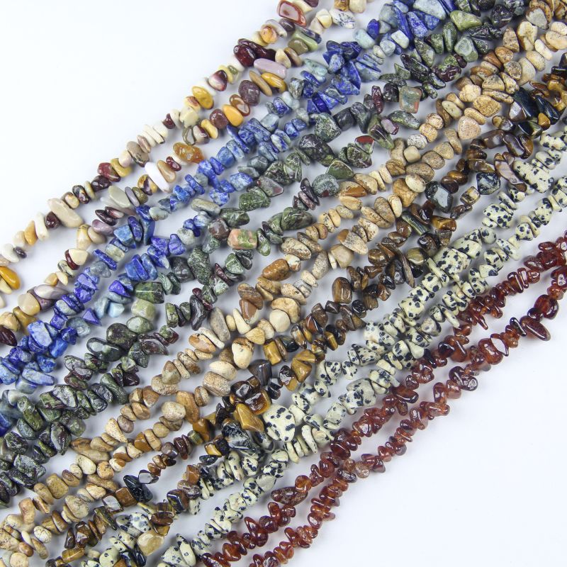 Collection of natural gemstone chip bead strands in multiple colors and materials, including agate, jasper, quartz, lapis lazuli, and tiger eye. 31.5 inch strands, 5-8mm chips, for jewelry making and DIY crafts.