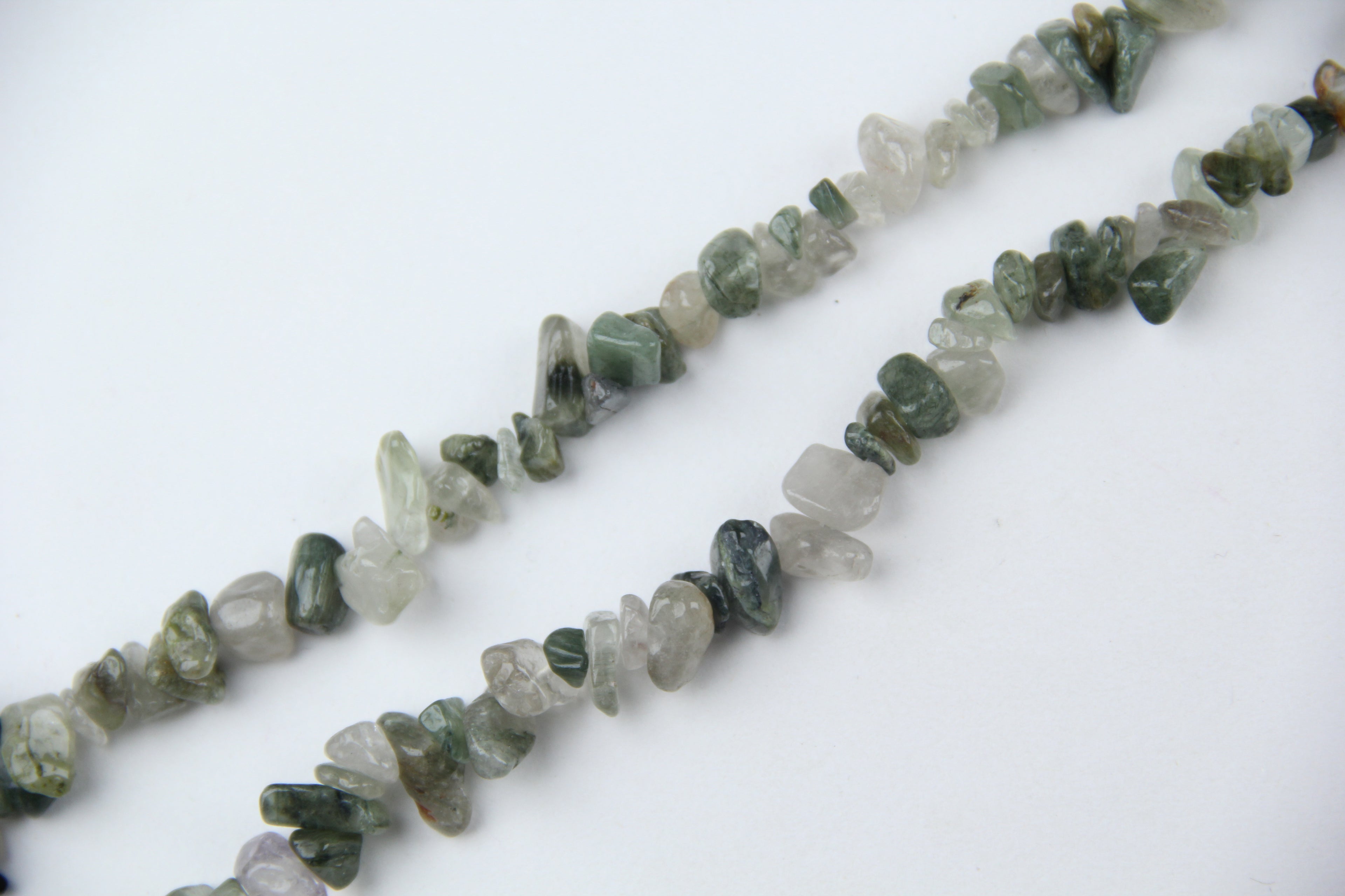 Irregular long chain of green hair crystals