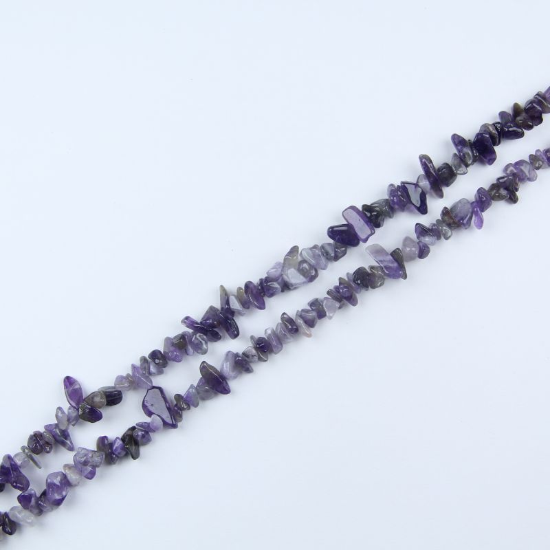 single flat lay of amethyst necklace strand, 31.5 inches, 5-8mm irregular round beads strung on nylon cord