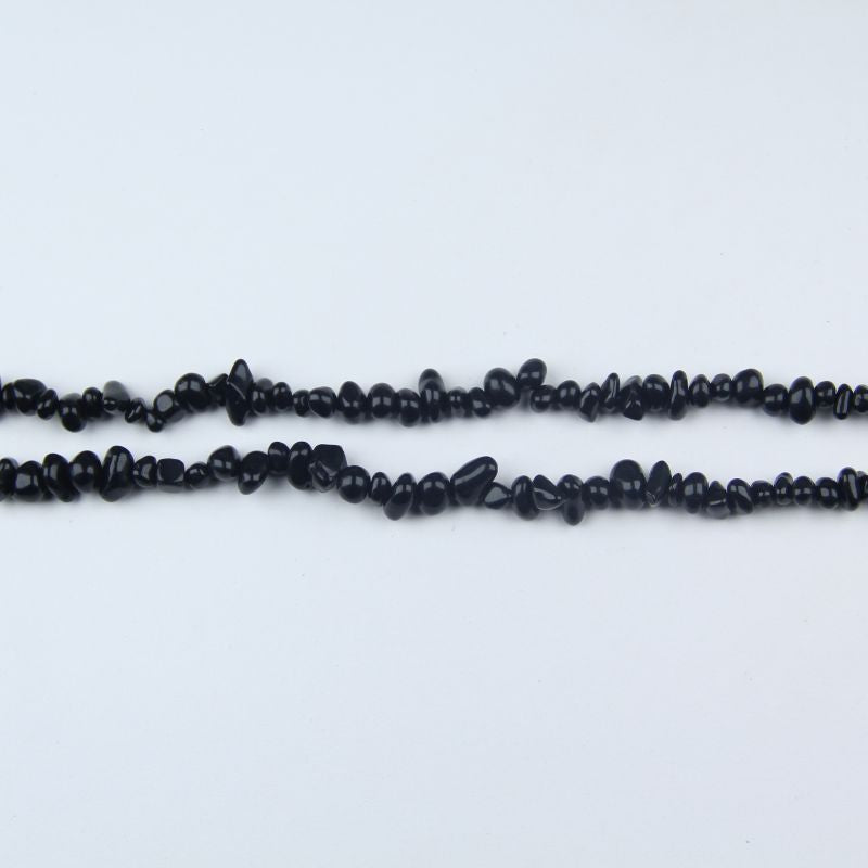 31.5 inch black obsidian irregular bead necklace laid flat on white background