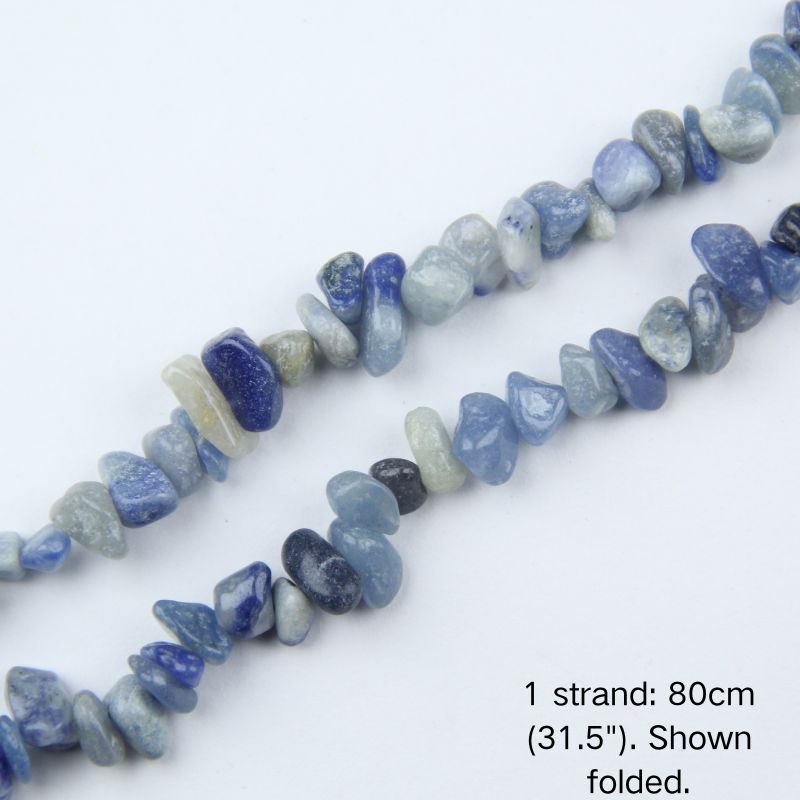 Macro close-up of glossy Blue Aventurine 5-8mm irregular chip beads showing polished texture, translucency, and center-drilled holes.
