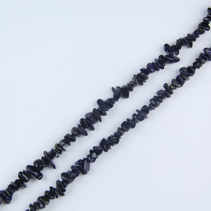 Single irregular blue sandstone chip bead necklace laid flat on light surface, 31-inch strand with organic chip-shaped beads