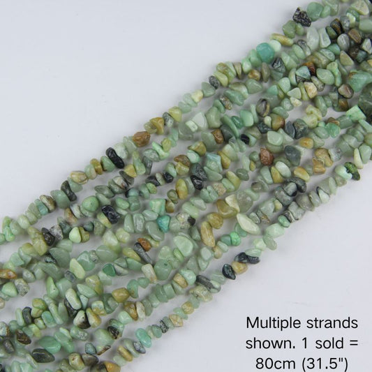 Multiple strands of natural Amazonite irregular chip beads laid out flat, 31.5 inches long, displaying a mix of seafoam green and white tones.