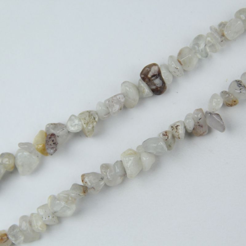 Close-up of cherry blossom agate beads, showing delicate pink and white flower-like mineral inclusions suspended inside translucent agate