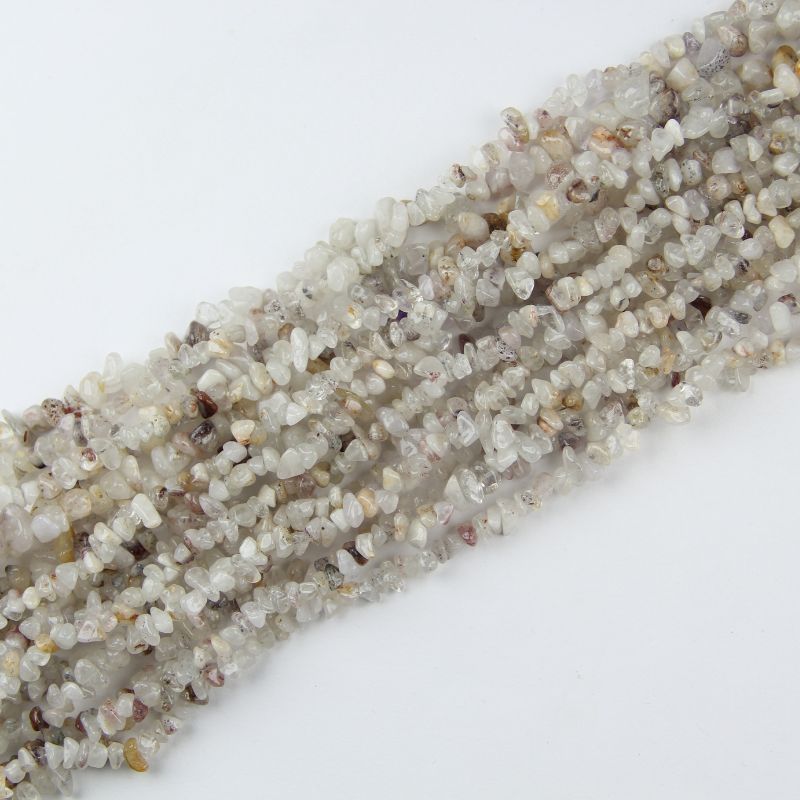 Multiple cherry blossom agate long necklaces stacked together, showing variation in pink tones and floral patterns between strands