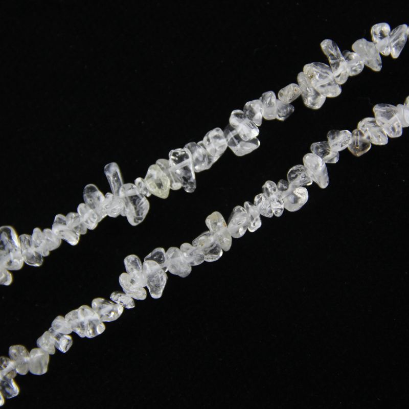 close-up of clear quartz irregular round beads showing transparency and nylon cord stringing, 5-8mm size