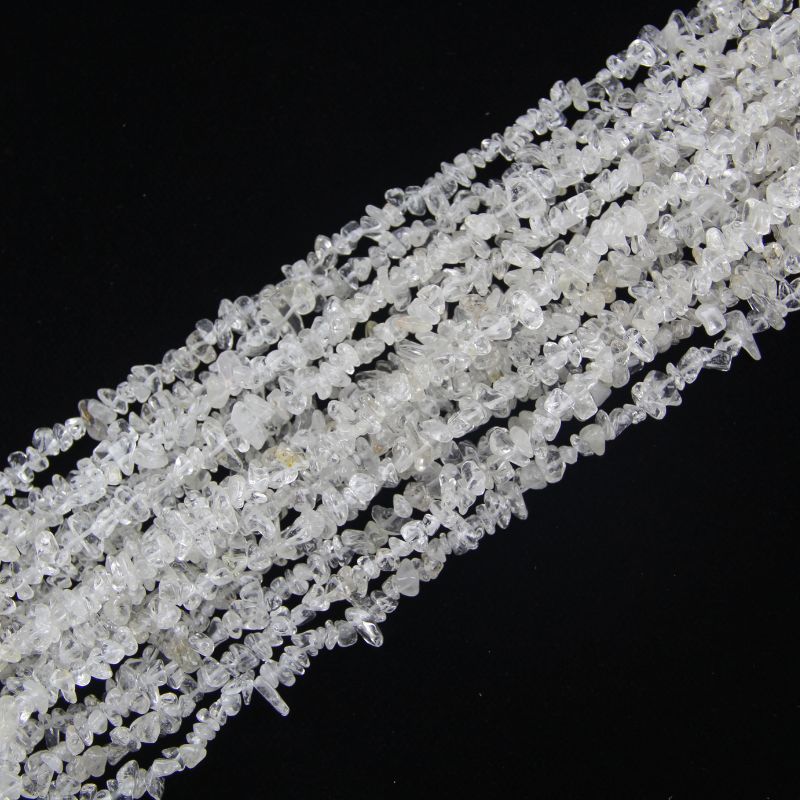 stacked coils of clear quartz bead strand, 31.5 inches long, irregular round 5-8mm beads on nylon cord