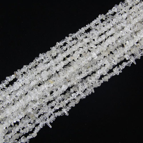 stacked coils of clear quartz bead strand, 31.5 inches long, irregular round 5-8mm beads on nylon cord