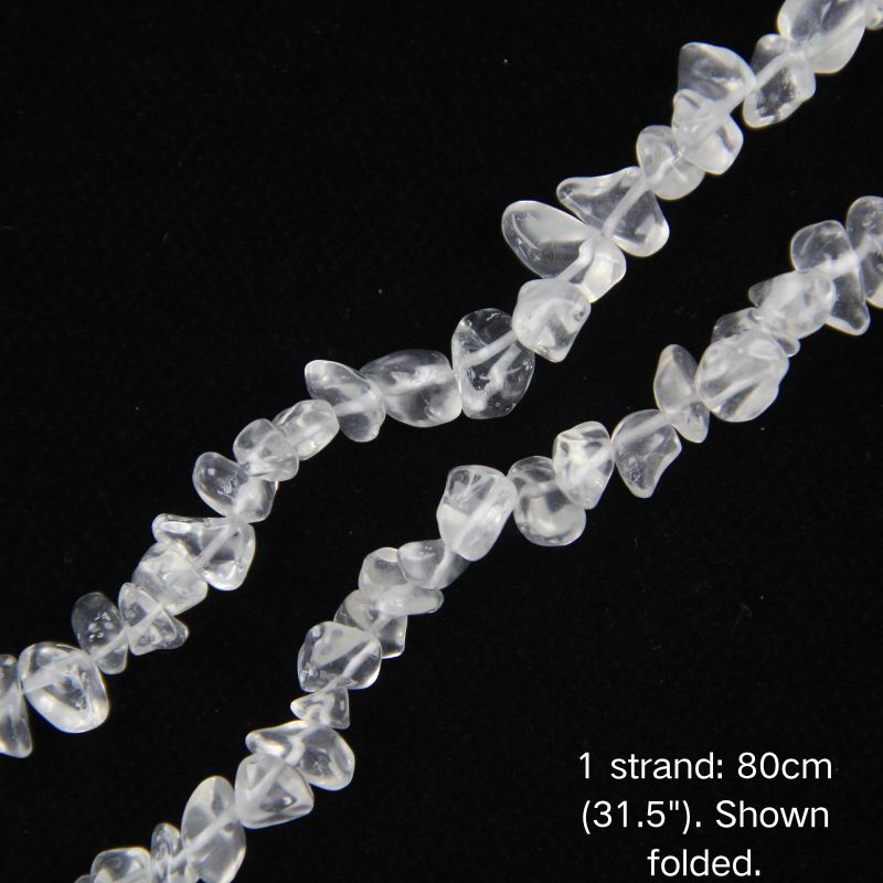 Macro close-up of glossy clear white 5-8mm irregular glass chip beads, showcasing the polished texture, translucency, and center-drilled holes.