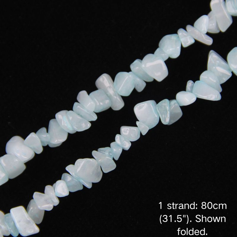 Close-up of 5-8mm irregular milky blue chalcedony stone nuggets on nylon cord.