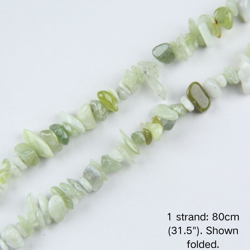 Close-up of 5-8mm creamy natural mint green jade stone chips with natural inclusions strung on nylon cord.