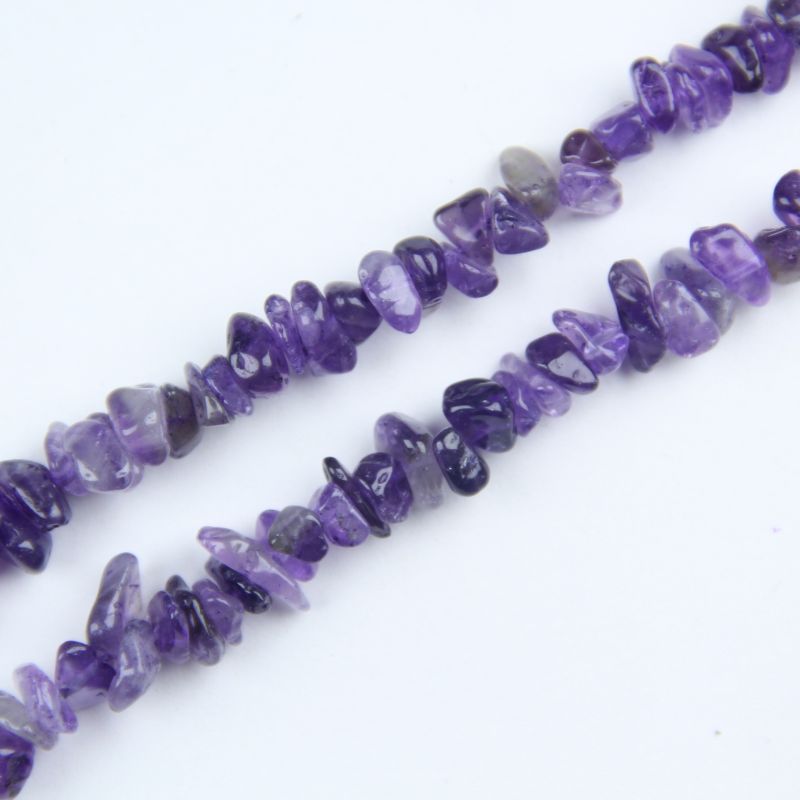 close-up of deep amethyst irregular round beads showing rich purple color and nylon cord stringing, 5-8mm size