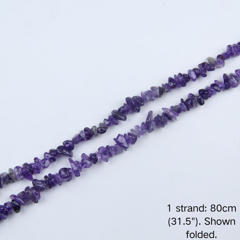 A single 80cm (31.5") strand of Deep Amethyst irregular crystal chip beads, shown folded to display actual length and nylon cord.