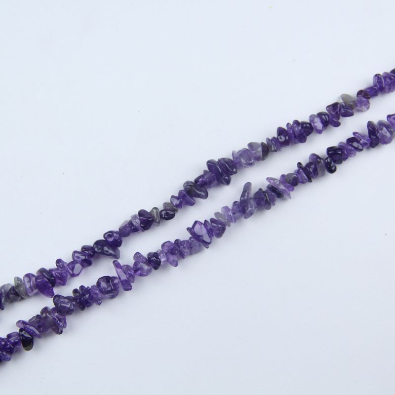 single flat lay of deep amethyst necklace strand, 31.5 inches, 5-8mm irregular round beads strung on nylon cord