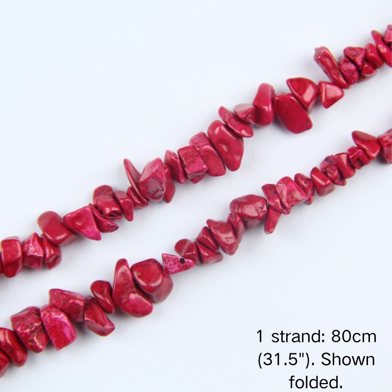 Close-up detail of dyed red howlite chip beads showing 5-8mm irregular nuggets with vibrant red color and crack lines.