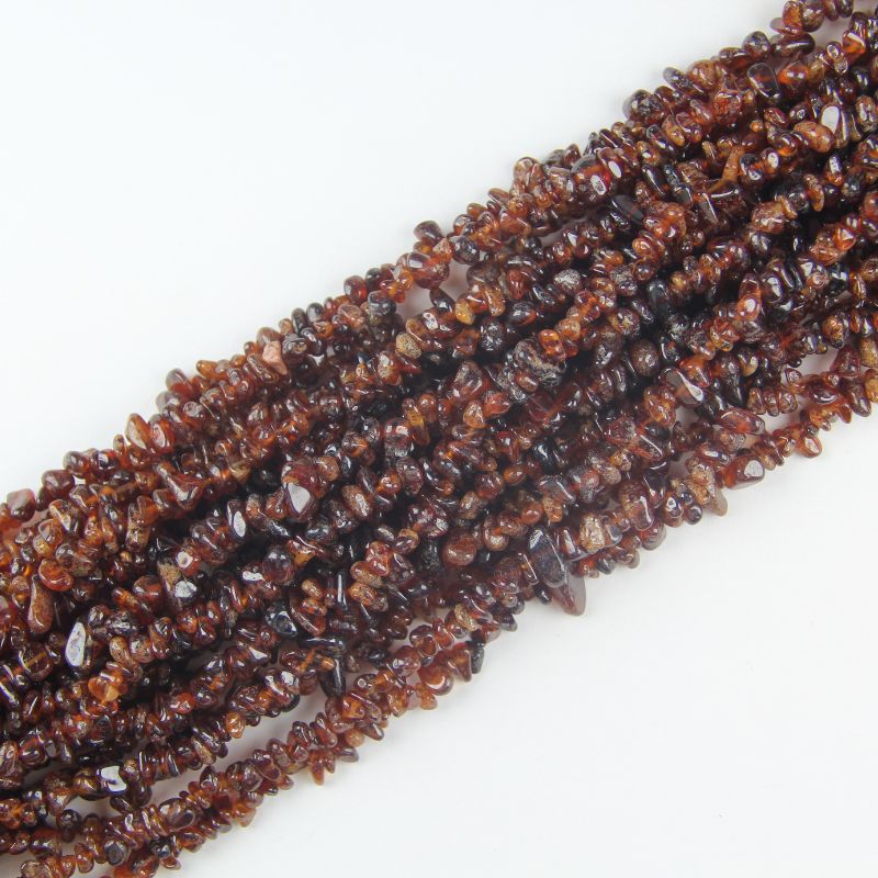 Fanta Garnet bracelet stacked in multi-loop coils, orange garnet beaded jewelry flat lay