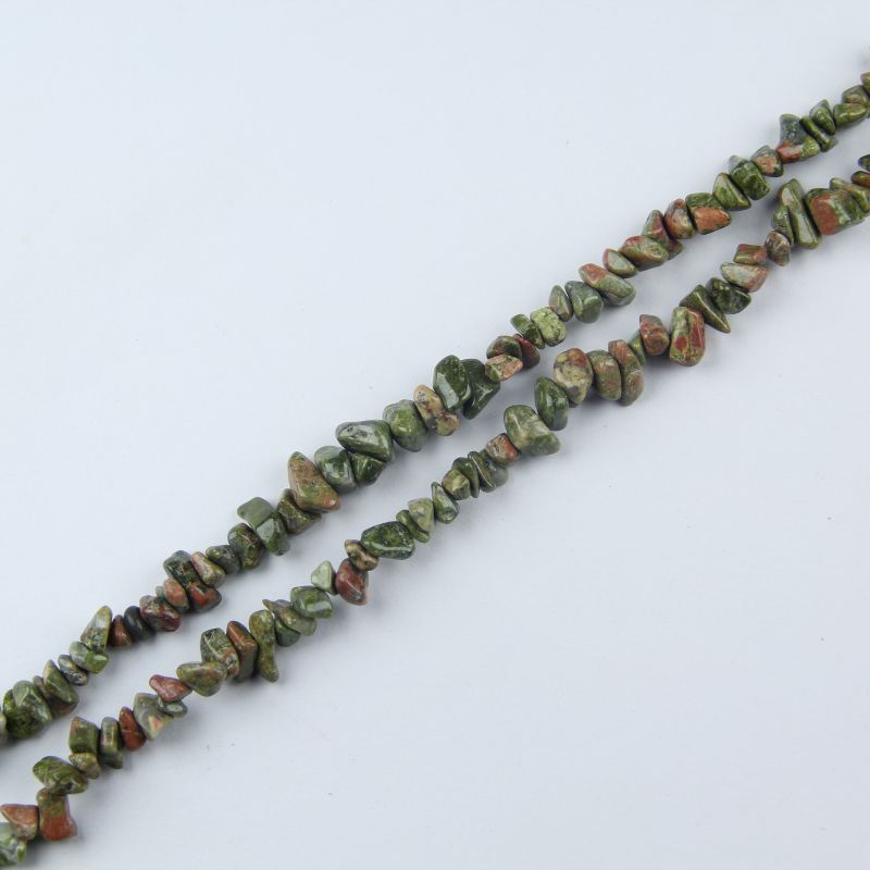 Flat lay of single natural spiderweb turquoise strand – 31.5 inches long, 5-8mm irregular round beads