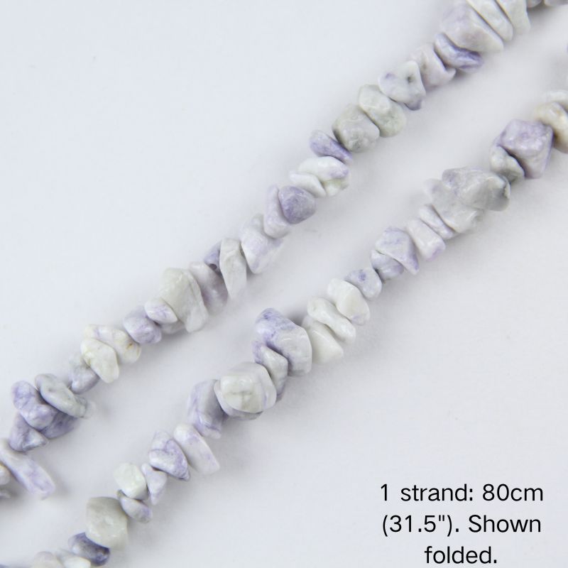 Close-up of a folded natural purple lace jasper chip bead strand, showing polished purple and white lace patterns in 5-8mm sizes.