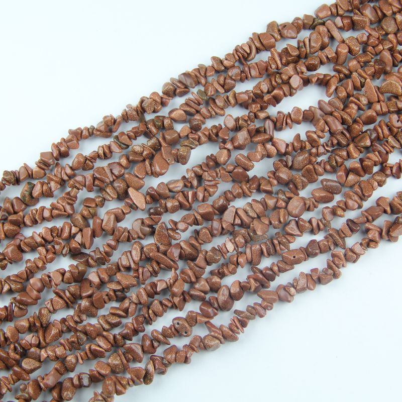 Irregular gold sandstone chip bead long necklace on white background, warm golden brown glass beads with thousands of tiny copper sparkle particles visible