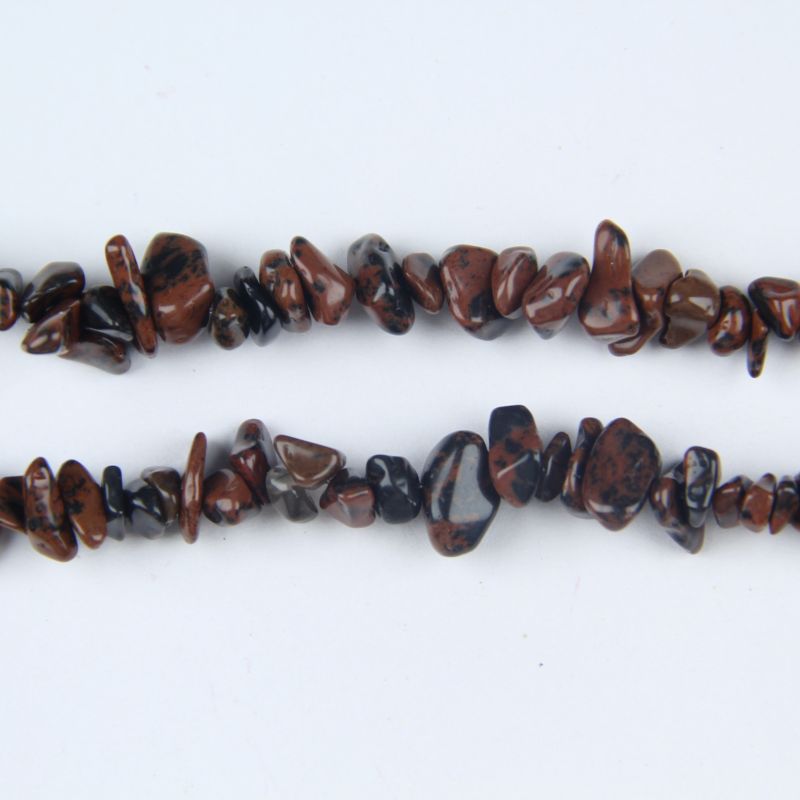 macro closeup of golden swan obsidian bead showing rich gold sheen and warm golden shimmer on volcanic glass surface