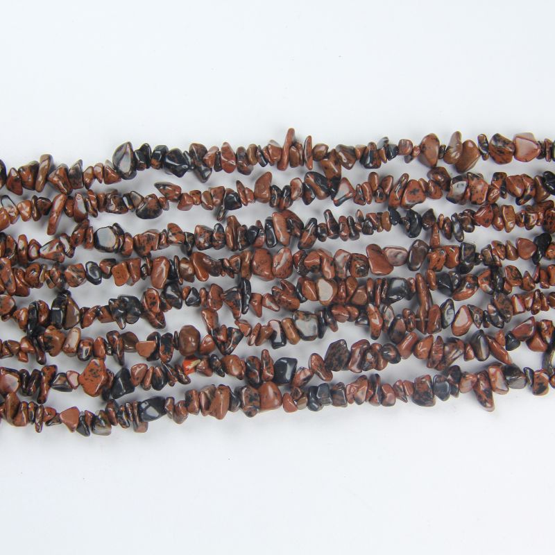 multiple golden swan obsidian long necklaces laid side by side on white background comparing gold sheen across strands