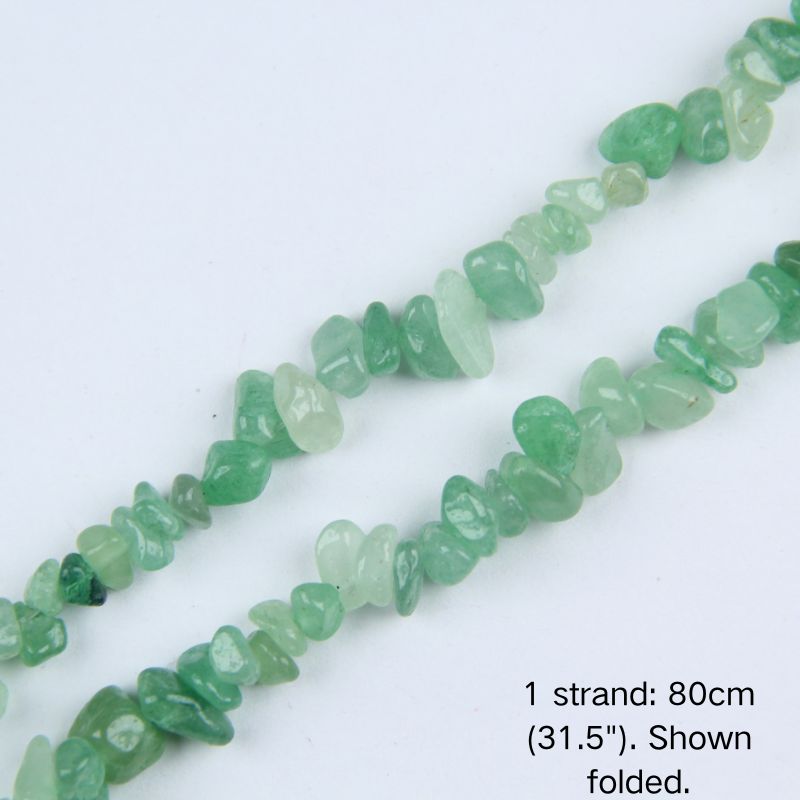 Macro close-up of glossy Green Aventurine 5-8mm irregular chip beads showing polished texture, translucency, and center-drilled holes.