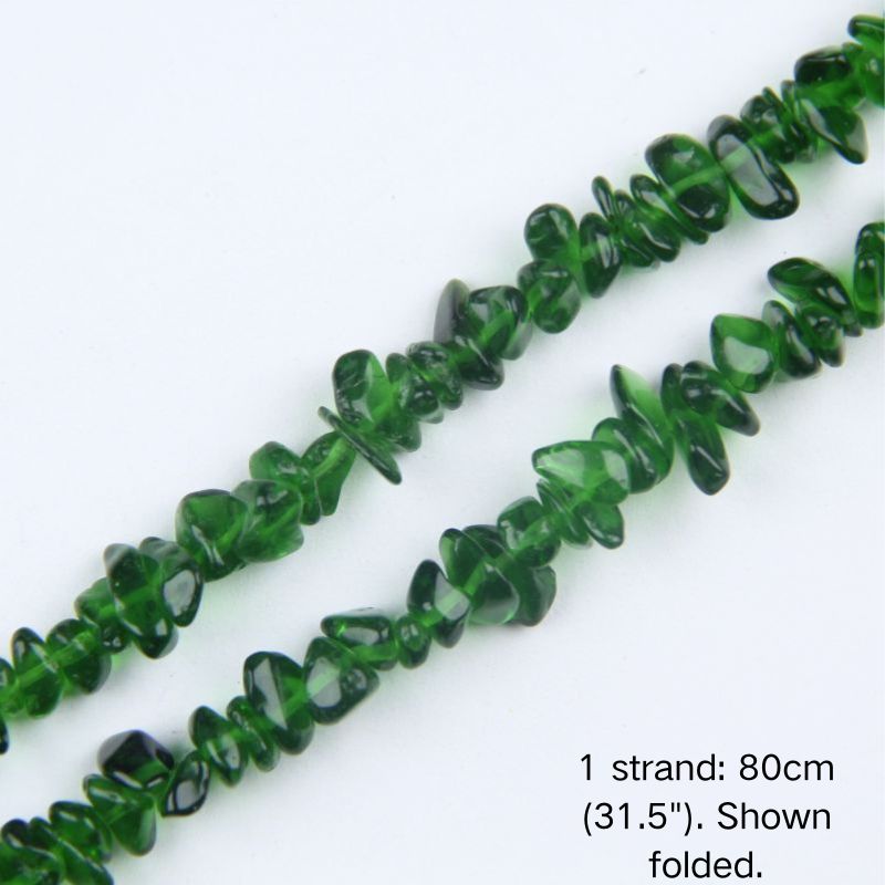Macro close-up of glossy green 5-8mm irregular glass chip beads, showcasing the polished texture, translucency, and center-drilled holes.