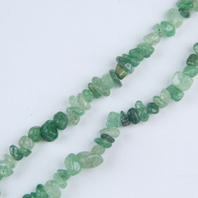 close-up of green strawberry quartz irregular round beads showing soft green color and sparkly inclusions with nylon cord stringing, 5-8mm size