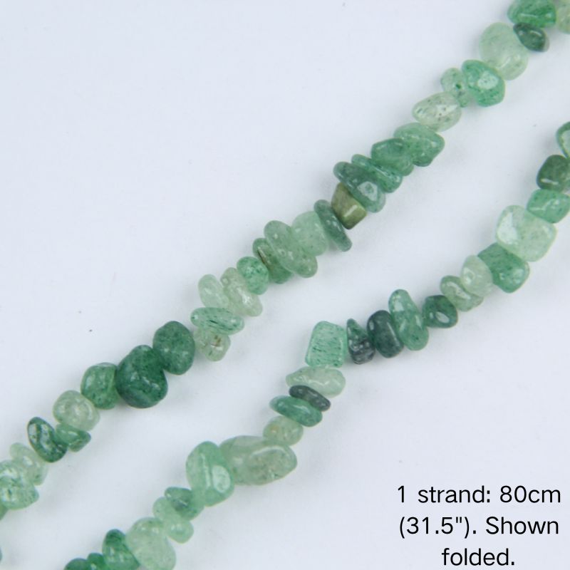 Macro close-up of green strawberry quartz chip beads, 5-8mm polished irregular chips with natural green dot inclusions.