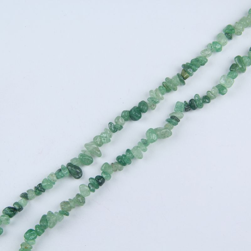 single flat lay of green strawberry quartz necklace strand, 31.5 inches, 5-8mm irregular round beads strung on nylon cord