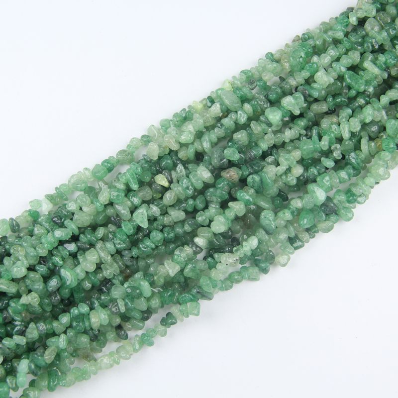 stacked coils of green strawberry quartz bead strand, 31.5 inches long, irregular round 5-8mm beads on nylon cord