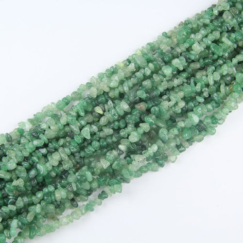 stacked coils of green strawberry quartz bead strand, 31.5 inches long, irregular round 5-8mm beads on nylon cord