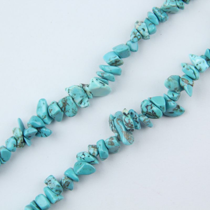 close-up of green turquoise irregular round beads showing earthy green color and dark matrix veining with nylon cord stringing, 5-8mm size