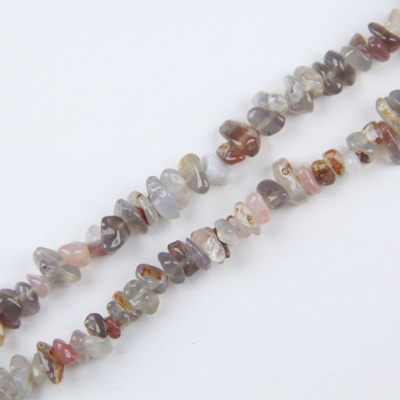 Close-up of natural grey agate beads, showing silver grey color, subtle white banding, and natural texture