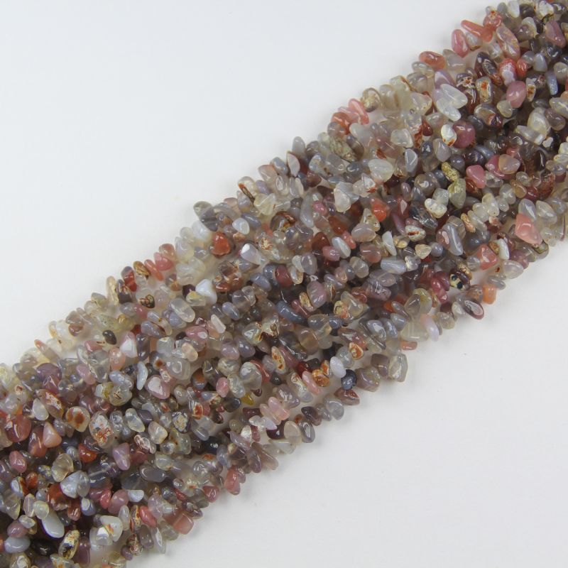 Multiple grey agate long necklaces stacked together, showing soft silver grey hues and natural white banding variations