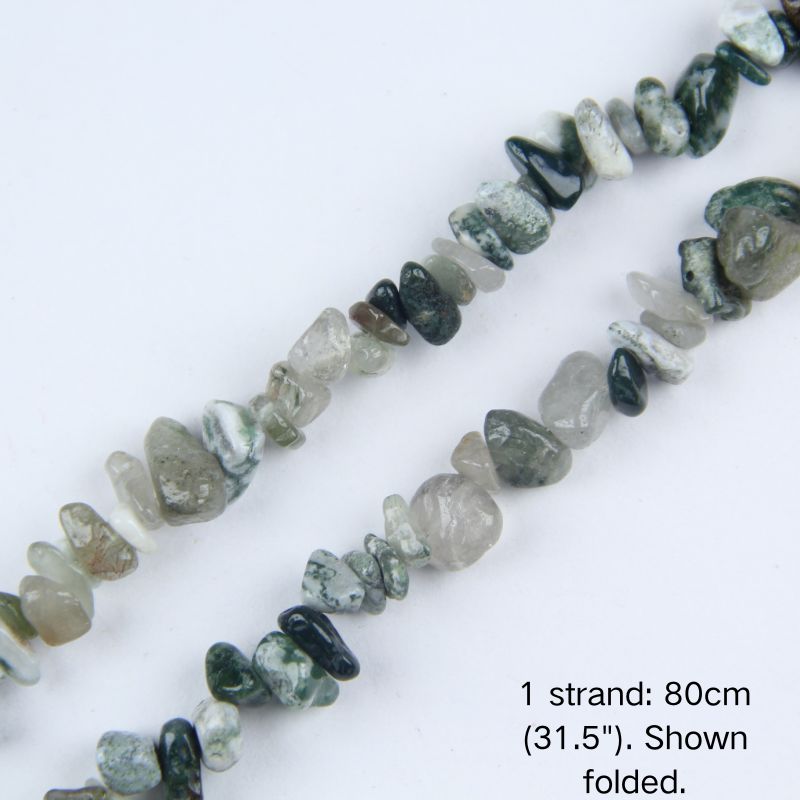 Macro close-up of glossy Indian Agate 5-8mm irregular chip beads, showing polished surface, rich earthy greens and browns, translucency, and center-drilled holes for threading.
