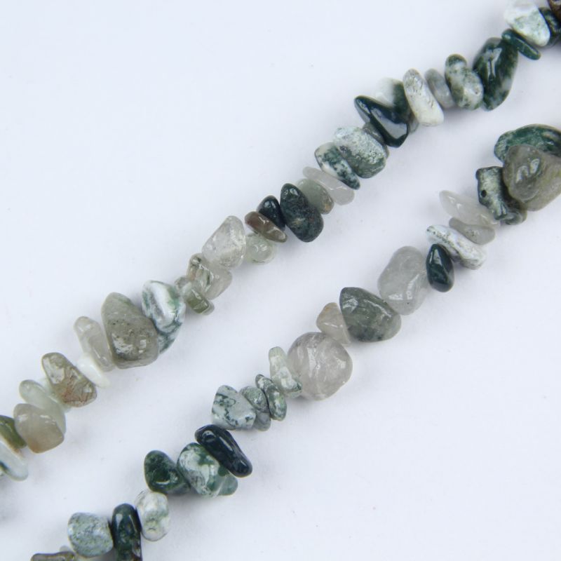 Close-up of Indian agate beads, showing natural eye patterns and concentric banding in earthy brown and cream tones