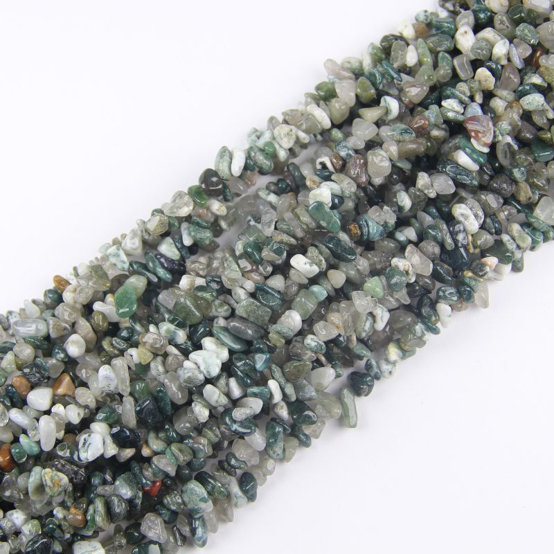 Multiple Indian agate long necklaces stacked together, showing variation in earthy colors and natural eye patterns between strands