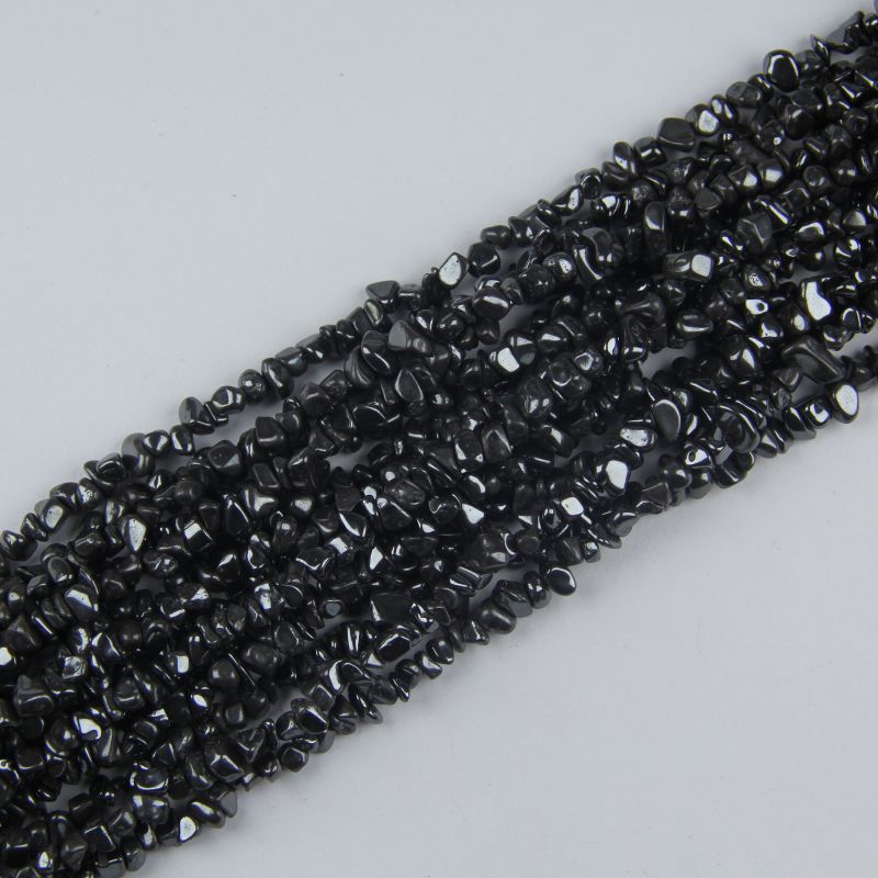 Multiple strands of natural iron stone beads stacked together, showing 5-8mm gray-black magnetic hematite chips with metallic sheen