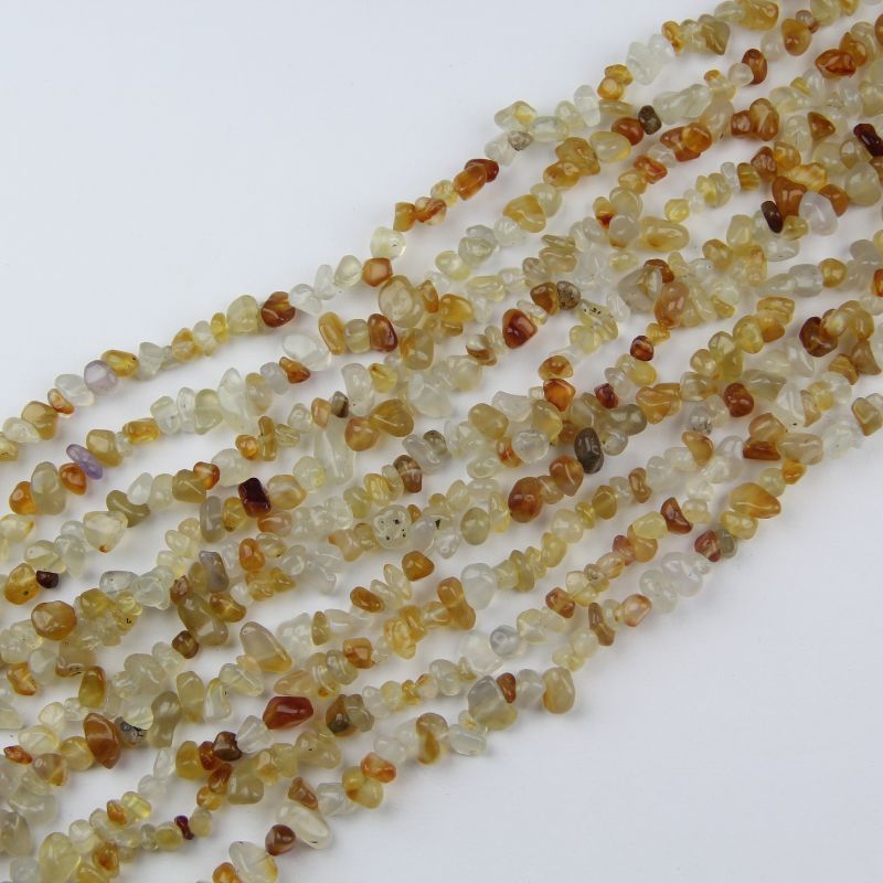 Irregular orange agate bead bracelet on white background, freeform round beads with natural orange and cream banding